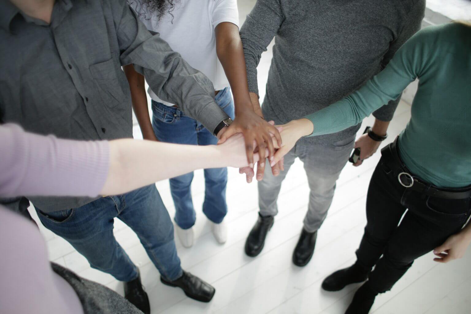 diverse people joining their hands bradenton research center 1