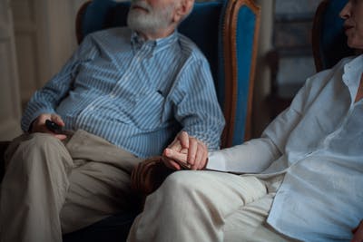 old couple holding hands while sitting alzheimer's study