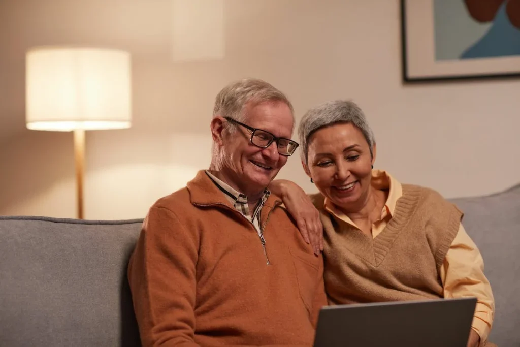 Man and woman with Alzheimer's looking at laptop